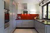 Kitchen with red splash back